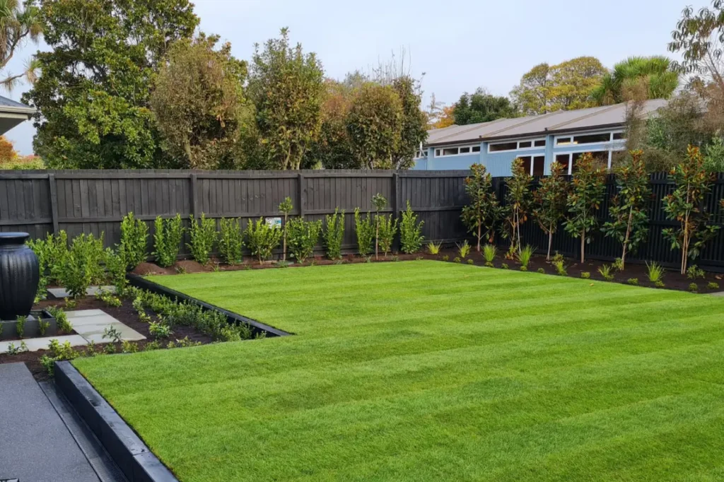Lush green lawn and structured garden layout by Friendly Build & Fix showcasing expert landscaping services.