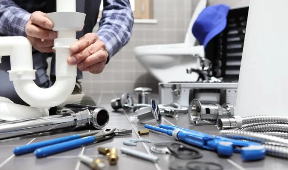 Friendly Build & Fix plumbingr repair bathroom piping with tools and fixtures spread out
