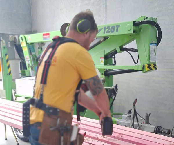 Skilled artisan crafting custom furniture at Friendly Build & Fix with values highlighted in our about us, contact us, privacy policy, and terms and conditions