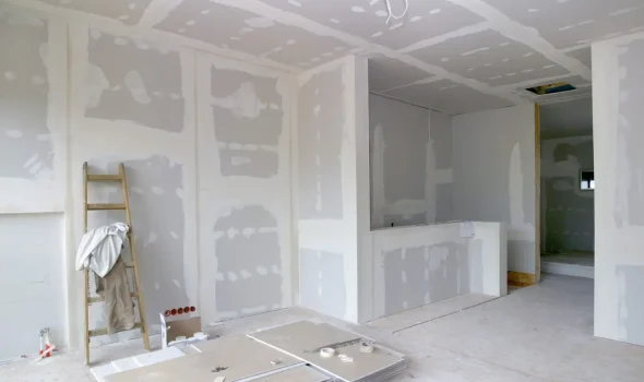 Room prepared for plaster and paint services by Friendly Build & Fix with drywall installation