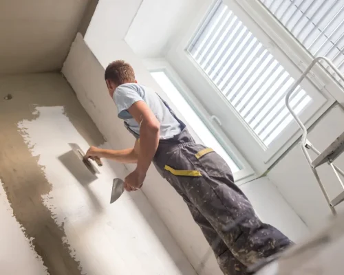 Expert applying plaster and paint on an interior wall – Friendly Build & Fix