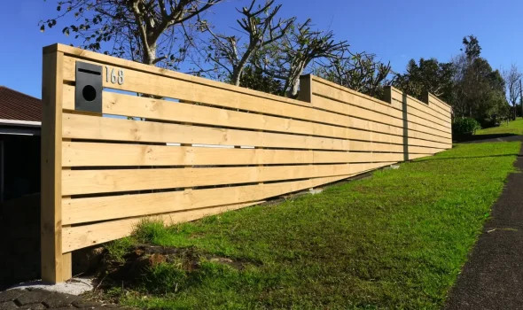 Horizontal slat timber fencing installed by Friendly Build & Fix along residential boundary
