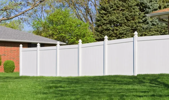 White vinyl privacy fencing installed by Friendly Build & Fix in a suburban backyard